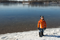 Wynne in front of an icy Cedar Lake